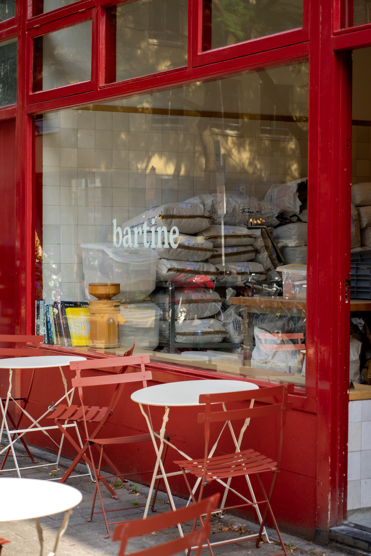 Bartine Bakery red storefront with bistro tables